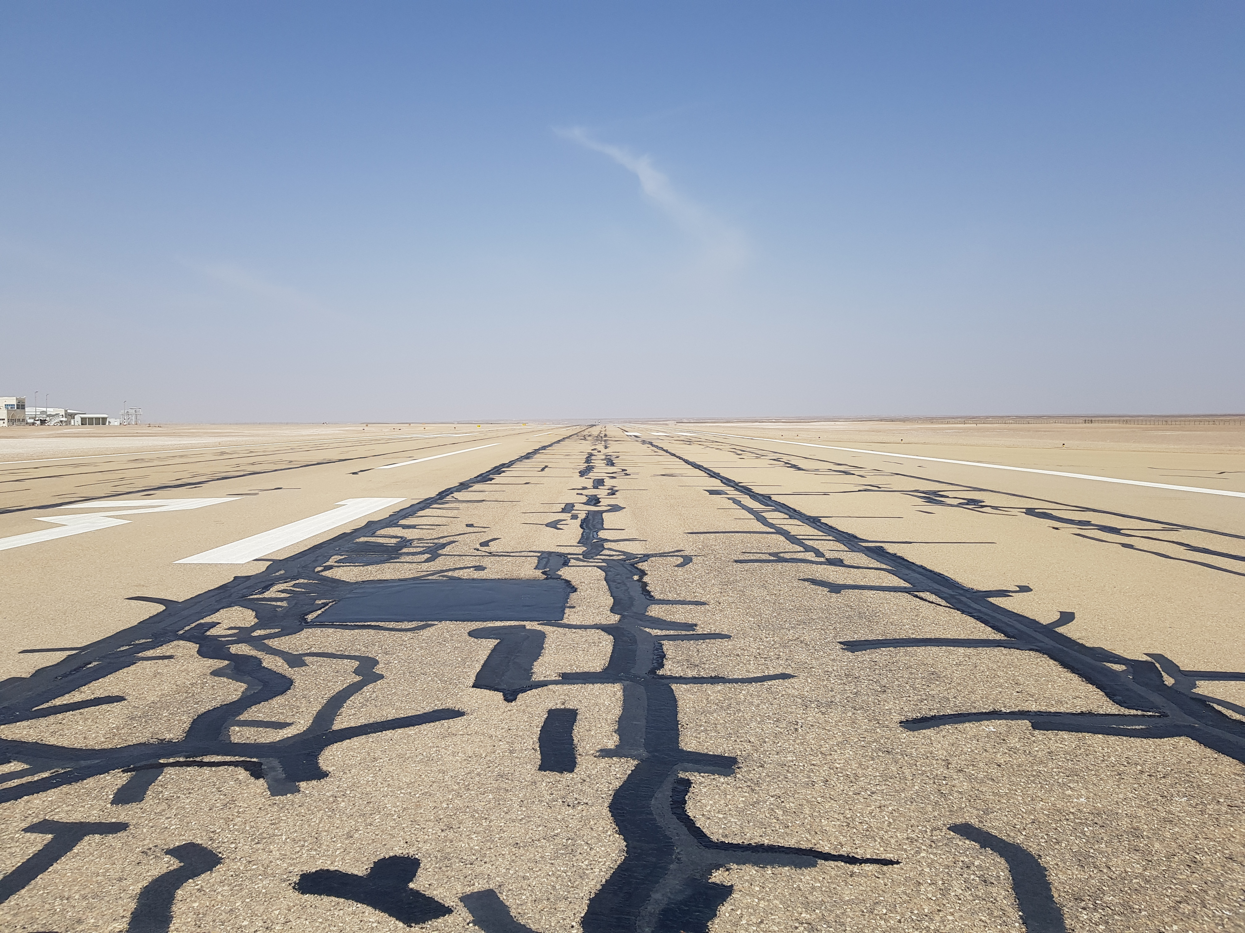 Runway pavement at Fahud Airport, Oman, showing longitudinal cracking and surface distress